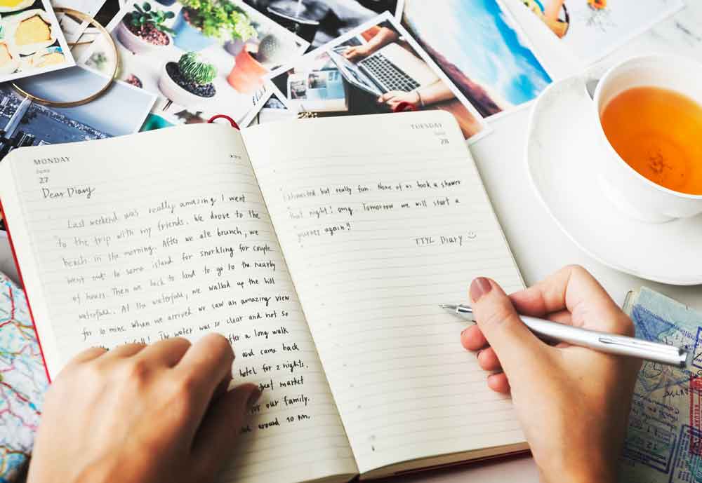 closeup-hands-writing-journal